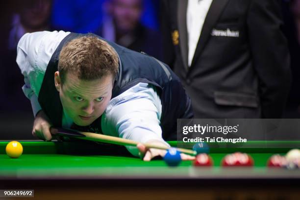 Shaun Murphy of England plays a shot during his first round match against Ali Carter of England on day four of The Dafabet Masters at Alexandra...