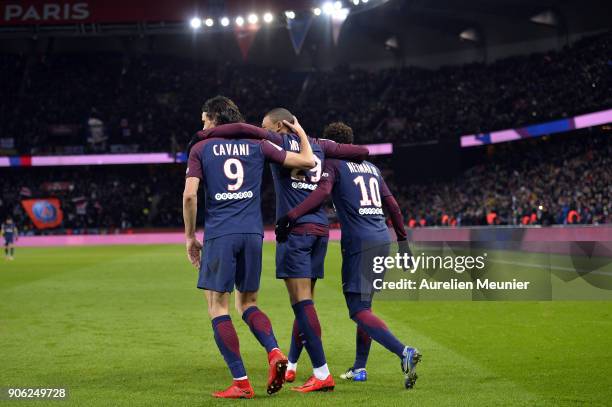 Kylian Mbappe of Paris Saint-Germain is congratulated by teammates Neymar Jr and Edinson Cavani after scoring during the Ligue 1 match between Paris...