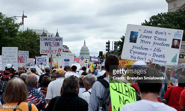 Protesters march to Capitol Hill during the Tea Party Express rally on September 12, 2009 in Washington, DC. Thousands of protesters gathered in...
