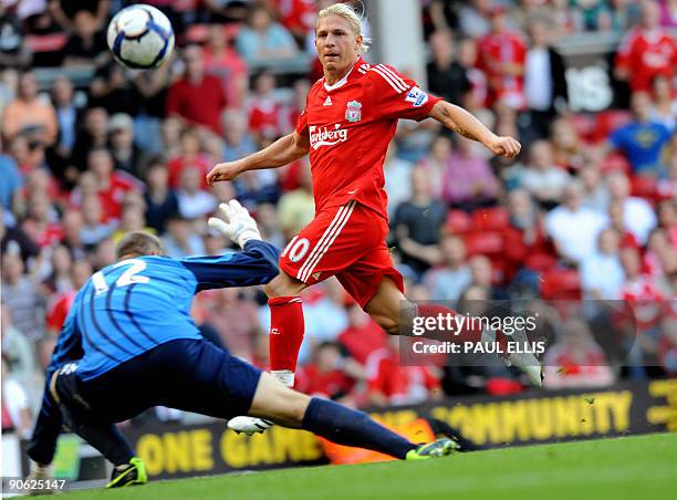 Liverpool's Ukranian forward Andriy Voronin puts the ball past Burnley's Danish goalkeeper Brian Jensen during the English Premier League football...