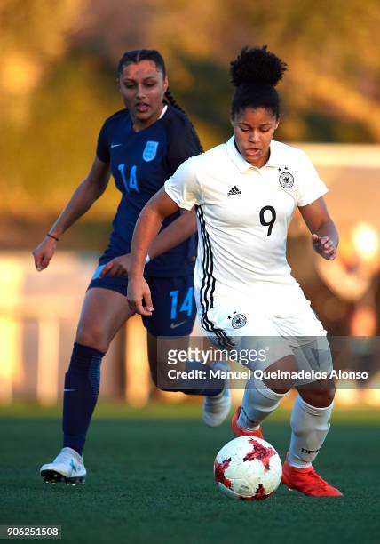 Shekiera Martinez of Germany competes for the ball with Simran Jhamat of England during the international friendly match between U17 Girl's Germany...