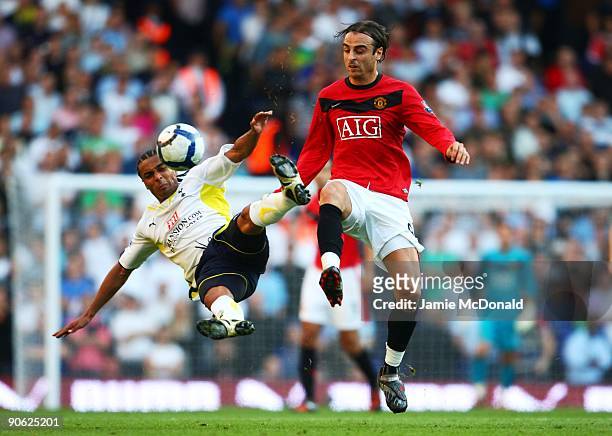 Benoit Assou-Ekotto of Tottenham and Dimitar Berbatov of Manchester United battle for the ball during the Barclays Premier League match between...