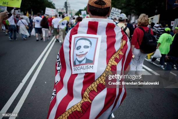 Protester wears an American Revolution era flag and an Obama picture during the Tea Party Express rally on September 12, 2009 in Washington, DC....