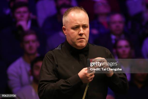 John Higgins of Scotland reacts during his first round match against Anthony McGill of Scotland on day four of The Dafabet Masters at Alexandra...