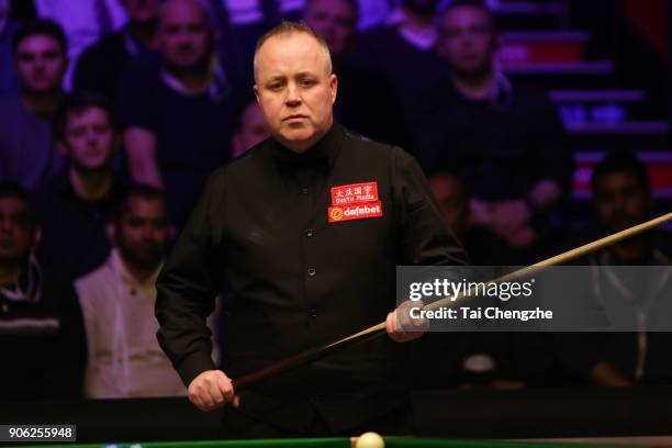 John Higgins of Scotland reacts during his first round match against Anthony McGill of Scotland on day four of The Dafabet Masters at Alexandra...