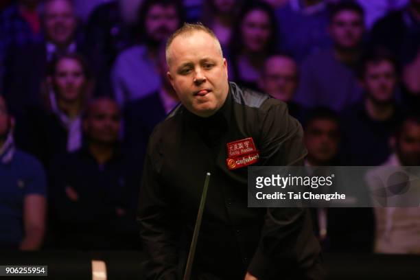 John Higgins of Scotland reacts during his first round match against Anthony McGill of Scotland on day four of The Dafabet Masters at Alexandra...