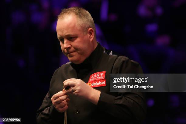 John Higgins of Scotland reacts during his first round match against Anthony McGill of Scotland on day four of The Dafabet Masters at Alexandra...