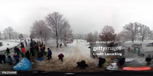 General view as dozens of people gather to sled at Dorothea Dix Park during a snow storm on January 17, 2018 in Raleigh, North Carolina. North...