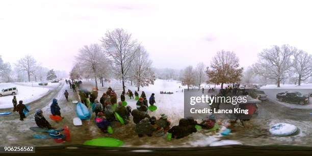 General view as dozens of people gather to sled at Dorothea Dix Park during a snow storm on January 17, 2018 in Raleigh, North Carolina. North...