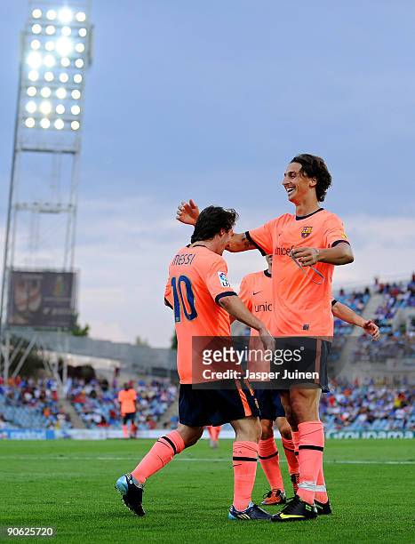 Lionel Messi of Barcelona celebrates scoring his side's second goal with his team mate Zlatan Ibrahimovic during the La Liga match between Getafe and...