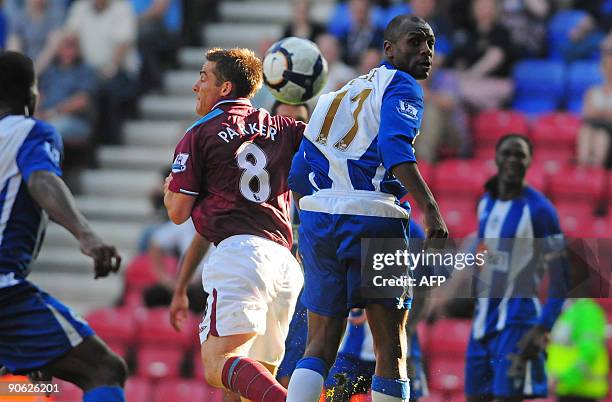 West Ham's English midfielder Scott Parker vies with Wigan's English defender Emmerson Boyce during the English Premier League football match between...