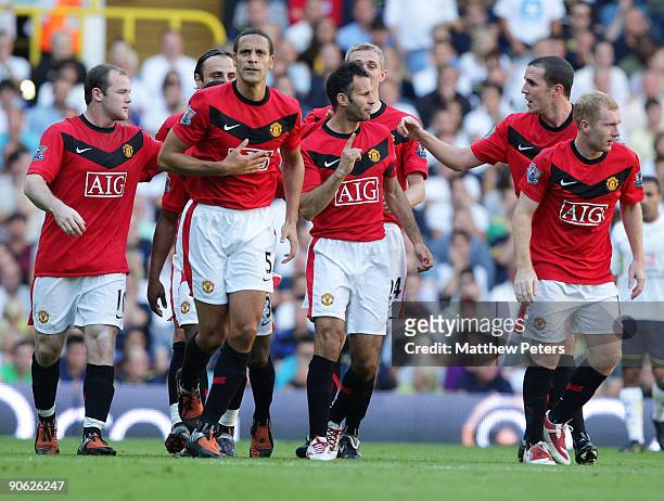 Ryan Giggs of Manchester United celebrates with his team mates after scoring their first goal during the FA Barclays Premier League match between...
