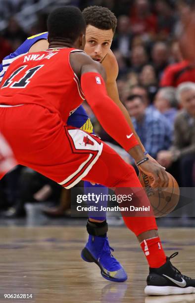 Stephen Curry of the Golden State Warriors looks to move against David Nwaba of the Chicago Bulls at the United Center on January 17, 2018 in...