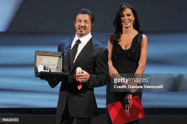 Actor Sylvester Stallone receives his Lifetime Achievement award from Maria Grazia Cucinotta while attending the Closing Ceremony at the Sala Grande...