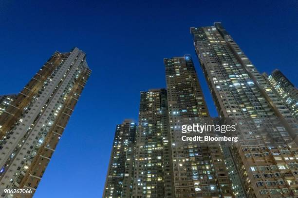 Residential buildings stand illuminated at the Metro Town development, jointly developed by CK Asset Property Holdings Ltd., Nan Fung International...