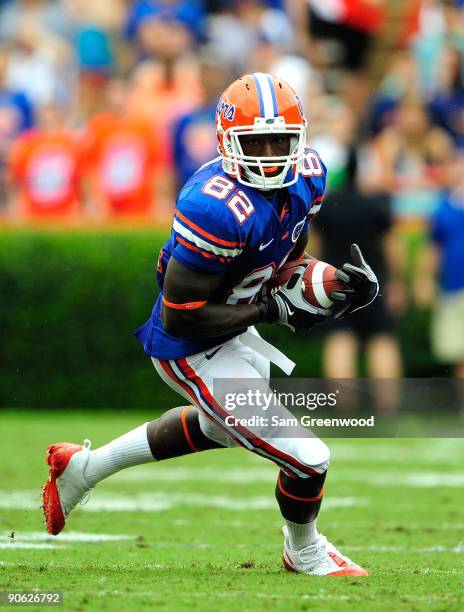 Omarius Hines of the Florida Gators runs for yardage during game against the Troy Trojans at Ben Hill Griffin Stadium on September 12, 2009 in...