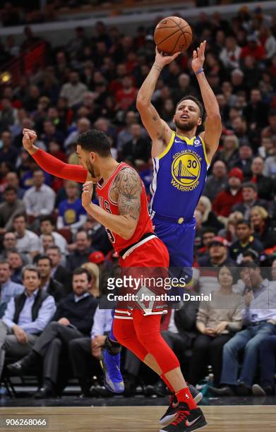 Stephen Curry of the Golden State Warriors is foued while shooting by Denzel Valentine of the Chicago Bulls at the United Center on January 17, 2018...