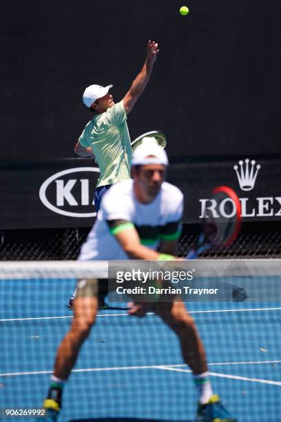Mischa Zverev of Germany serves in his first round men's doubles match with Paolo Lorenzi of Italy against Lukasz Kubot of Poland and Marcelo Melo of...