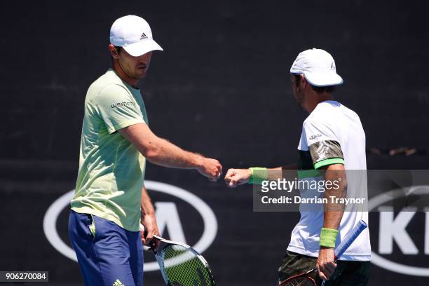 Mischa Zverev of Germany and Paolo Lorenzi of Italy talk tactics in their first round men's doubles match against Lukasz Kubot of Poland and Marcelo...