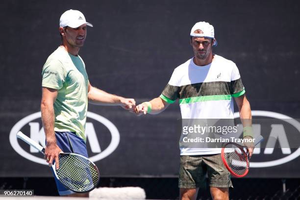 Mischa Zverev of Germany and Paolo Lorenzi of Italy talk tactics in their first round men's doubles match against Lukasz Kubot of Poland and Marcelo...