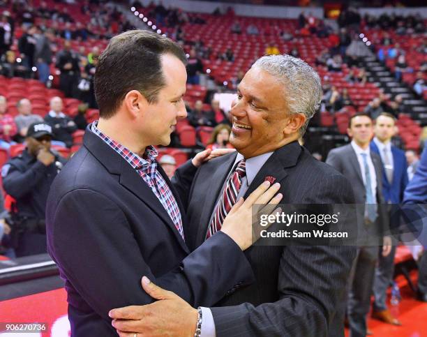 Head coach Paul Weir of the New Mexico Lobos and head coach Marvin Menzies of the UNLV Rebels exchange a greeting before their game at the Thomas &...