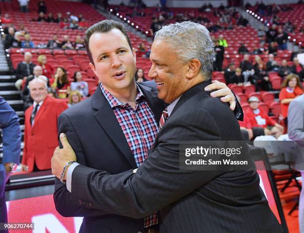Head coach Paul Weir of the New Mexico Lobos and head coach Marvin Menzies of the UNLV Rebels exchange a greeting before their game at the Thomas &...