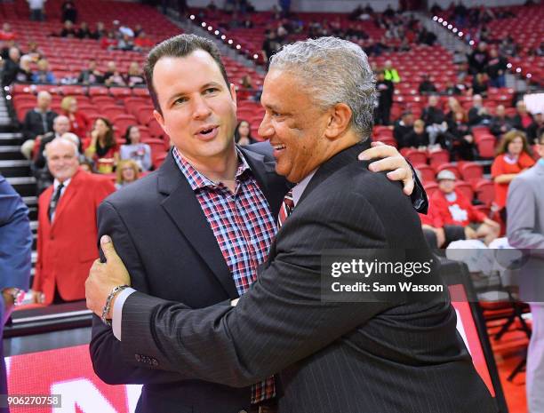 Head coach Paul Weir of the New Mexico Lobos and head coach Marvin Menzies of the UNLV Rebels exchange a greeting before their game at the Thomas &...