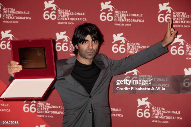 Director Fatih Akin poses with the Special Jury Prize for his film 'Soul Kitchen' the Closing Ceremony photocall at the Palazzo del Casino during the...