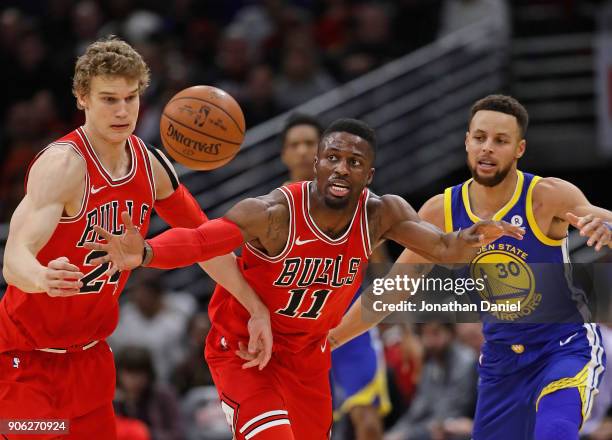 Lauri Markkanen and David Nwaba of the Chicago Bulls chase down a loose ball in front of Stephen Curry of the Golden State Warriors at the United...