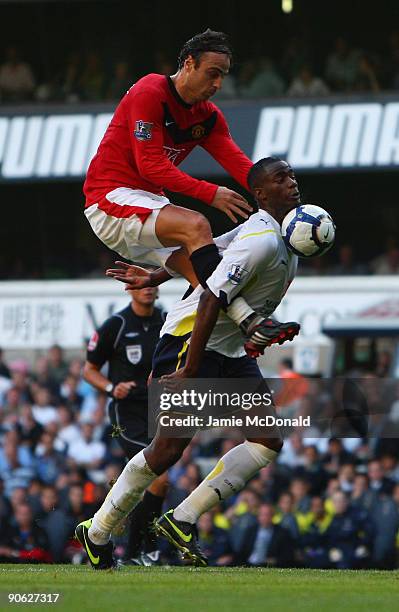 Dimitar Berbatov of Manchester United battles with Sebastien Bassong of Tottenham Hotspur during the Barclays Premier League match between Tottenham...