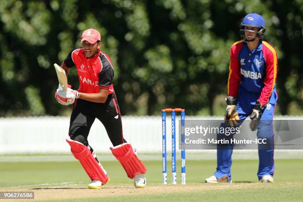 Akash Gill of Canada bats as wicketkeeper Lohan Louwrens of Namibia looks on during the ICC U19 Cricket World Cup match between Namibia and Canada at...