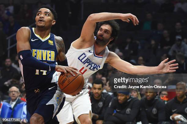 Milos Teodosic of the Los Angeles Clippers guards against Gary Harris of the Denver Nuggets as he drives to the basket in the first half of the game...
