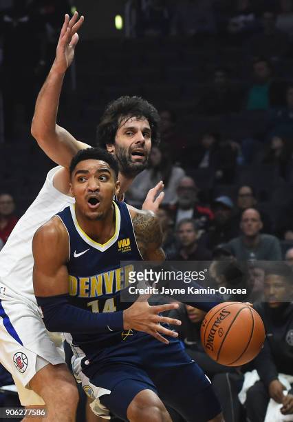 Milos Teodosic of the Los Angeles Clippers guards Gary Harris of the Denver Nuggets as he drives to the basket in the first half of the game at...