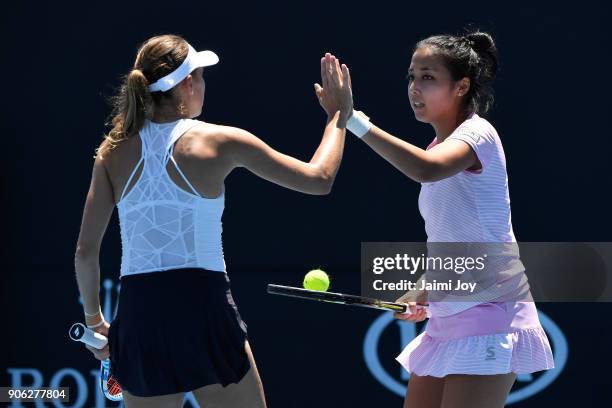 Isabelle Wallace of Australia and Naiktha Bains of Australia talk tactics in their first round women's doubles match against Zarina Diyas of...