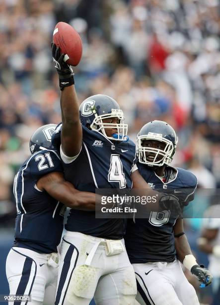 Twyon Martin of the Connecticut Huskies celebrates his fumble recovery with teammates Gary Wilburn and Jasper Howard in the second half against the...