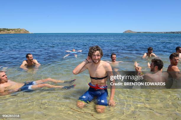 Bahrain-Merida rider Manuele Boaro of Italy has a swim in 41 degree Celsius heat with other riders after finishing on the third day of the Tour Down...