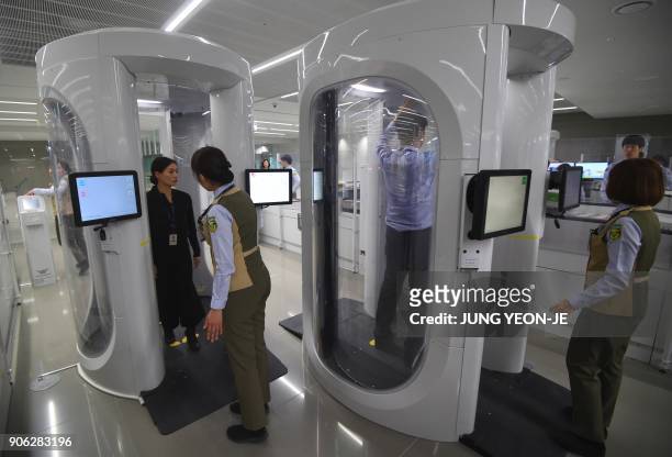 This picture taken on November 21, 2017 shows body scanners at a security checkpoint in Terminal 2 of Incheon International Airport, west of Seoul,...