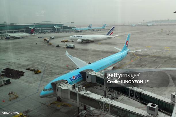 General view shows airplanes sitting on the tarmac at Terminal 2 of Incheon International Airport, west of Seoul, on January 18, 2018. - Incheon...
