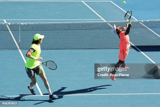 John-Patrick Smith of Australia and Nicholas Monroe of the United States compete in their first round men's doubles match against Nick Kyrgios of...