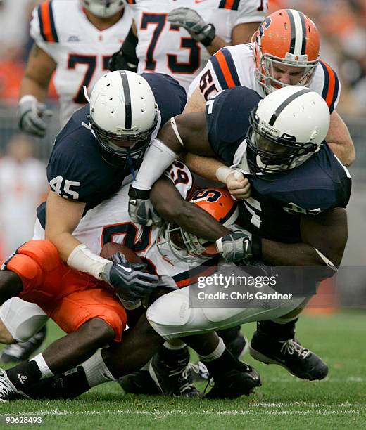 Linebacker Sean Lee and tackle Ollie Ogbu of the Penn State Nittany Lions tackle running back Antwon Bailey of the Syracuse Orangemen during the...