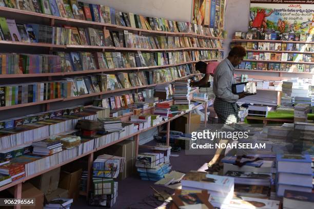 An Indian salesman arranges books inside a book store at the Hyderabad Book Fair on January 18, 2018. The Hyderabad book Fair runs from 18th to 28th...