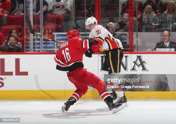 Marcus Kruger of the Carolina Hurricanes collides in open ice with Garnet Hathaway of the Calgary Flames during an NHL game on January 14, 2018 at...