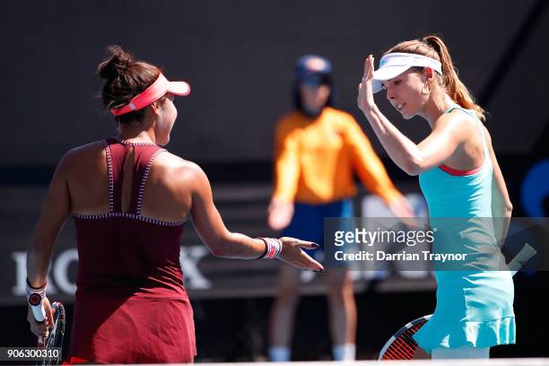 Alize Cornet of France and Heather Watson of Great Britain compete in their first round women's doubles match against Alicja Rosolska of Poland and...