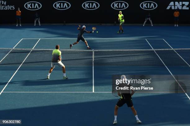 Lleyton Hewitt of Australia plays a backhand with in his first round men's doubles match Sam Groth of Australia against Denis Istomin of Uzbekistan...