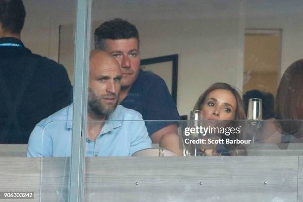 Former AFL footballer Chris Judd and his wife Rebecca Judd watch Ashleigh Barty of Australia play Camila Giorgi of Italy on day four of the 2018...