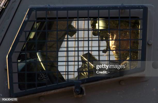 Member of the Israeli forces is seen inside a vehicle during a military operation in Jenin, in the north of the occupied West Bank, on January 18,...