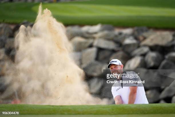 Stephen Gallacher of Scotland plays his second shot from a bunker on the seventh hole during round one of the Abu Dhabi HSBC Golf Championship at Abu...