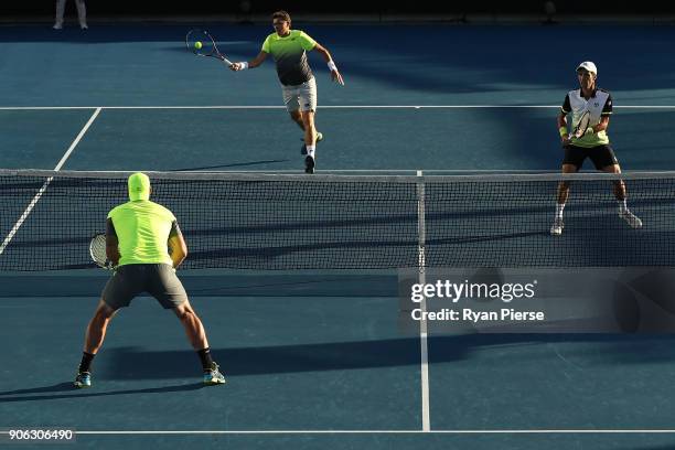 Denis Istomin of Uzbekistan plays a forehand in his first round men's doubles match with Mikhail Kukushkin of Kazakhstan against Sam Groth of...