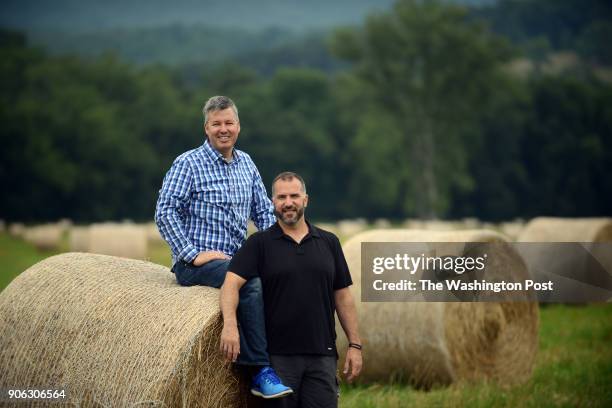 July 15: Hay bales are ready for pick up at the 150 acre farm of Paul Yandura, standing right, and his partner Donald Hitchcock who run several...