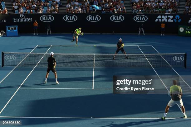 Sam Groth of Australi serves in his first round men's doubles match with Lleyton Hewitt of Australia against Denis Istomin of Uzbekistan and Mikhail...